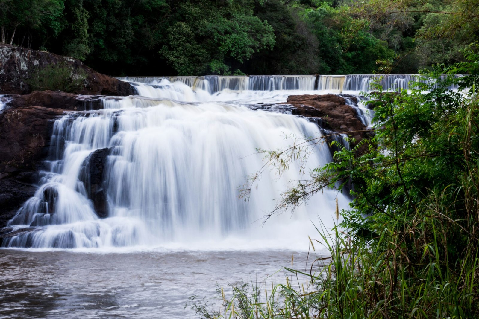 a large waterfall with water cascading down it's sides